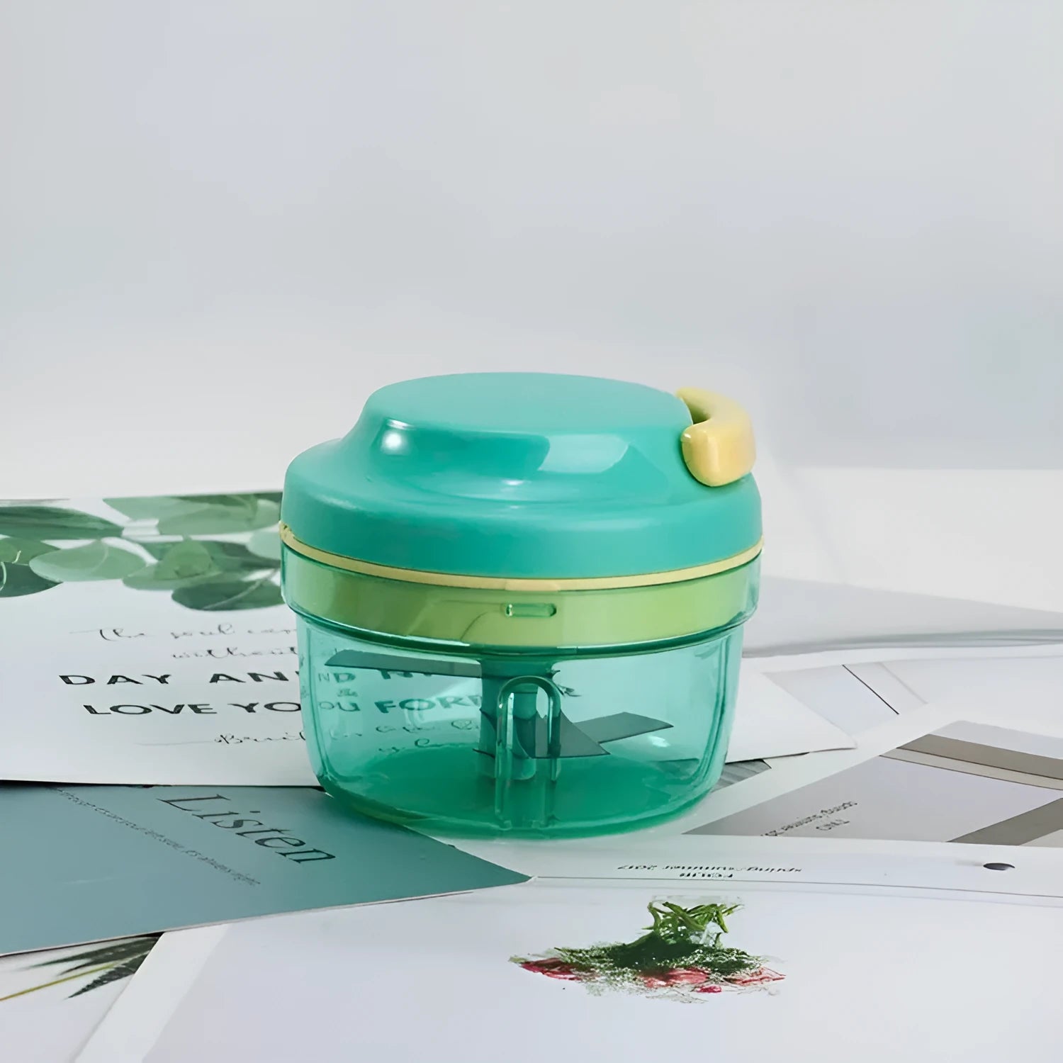 Green manual baby food maker and garlic grinder with stainless steel blade, 300ml capacity.