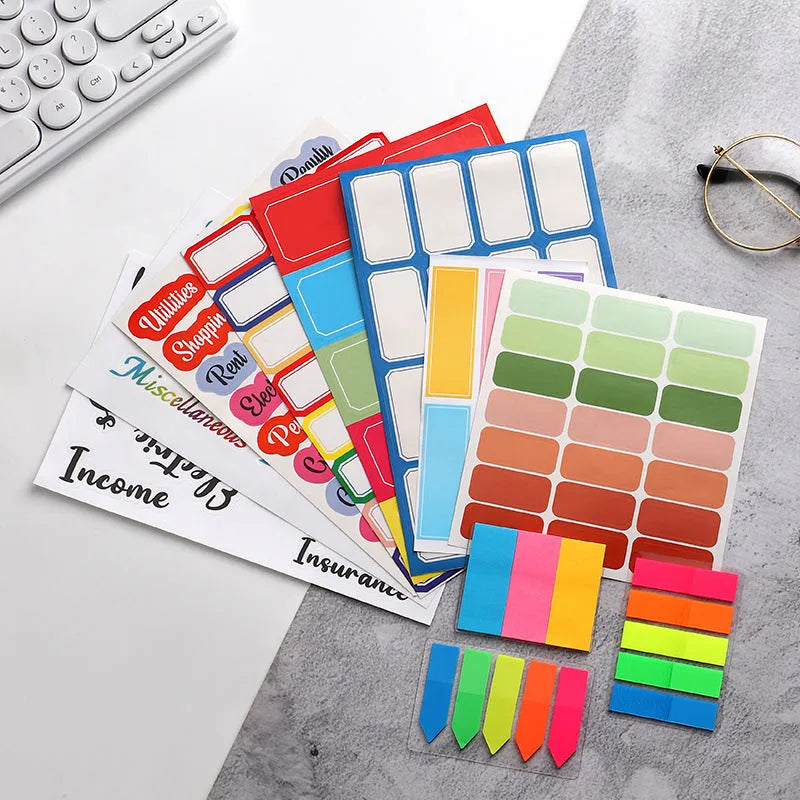 Assortment of handwritten label adhesive stickers showing A6 ruler, grid layouts, and coloured sticky notes.