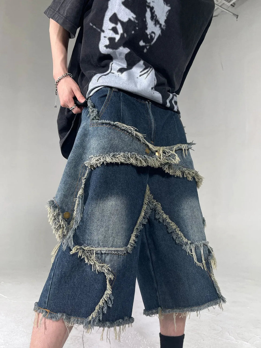 Blue American retro denim shorts with a frayed five-pointed star detail on the leg, shown in a loose fit.