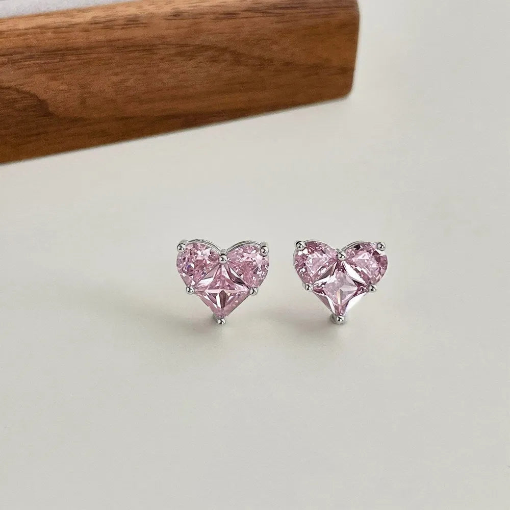 Pair of 925 sterling silver heart-shaped stud earrings with zircon detail and electroplated finish