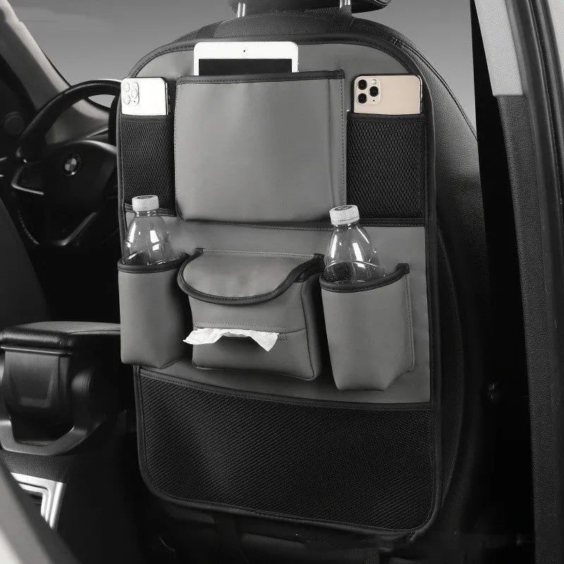 Leather car seat back storage bag in a choice of colours, shown hanging from a vehicle headrest.