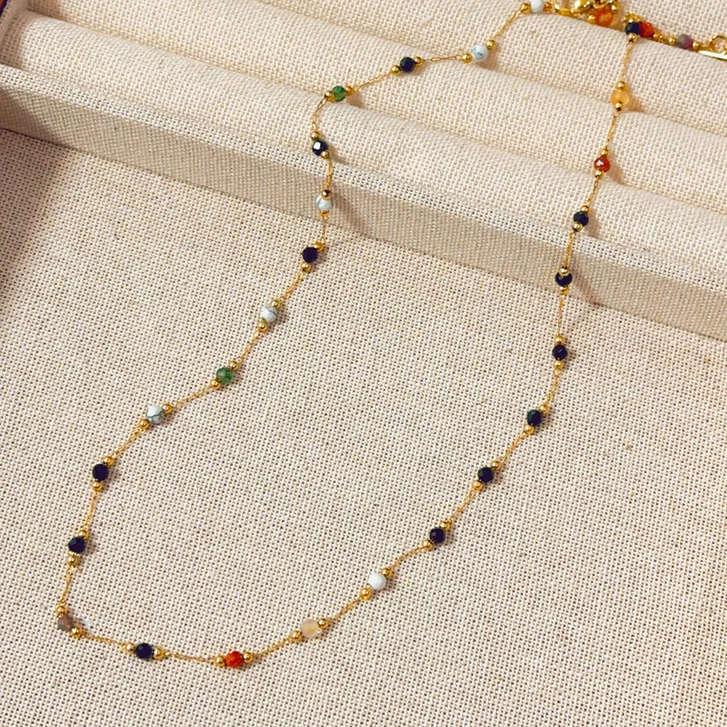 Gold coloured titanium steel necklace with natural stone pendant on O-ring chain.
