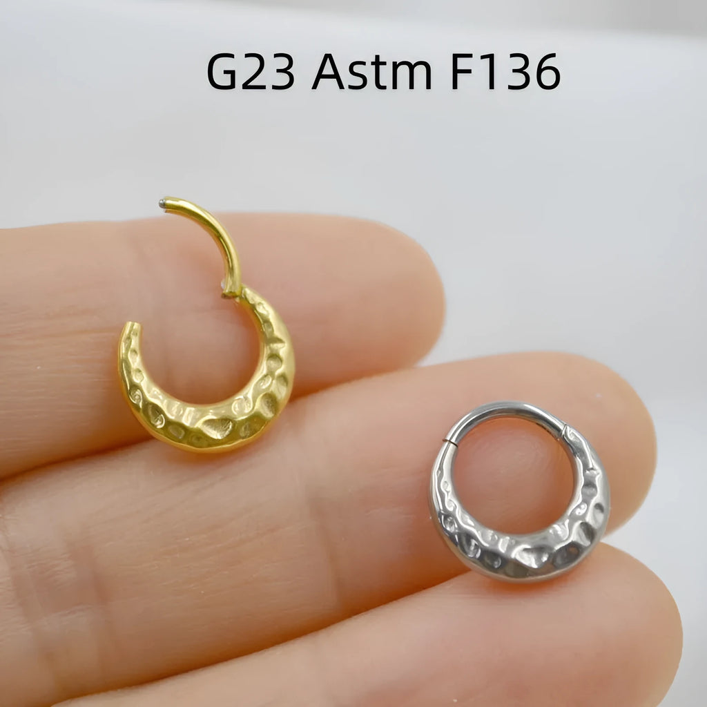 Close-up of a carved concave-convex titanium nose ring in silver finish