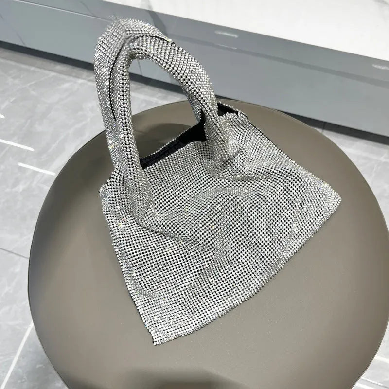 Silver shiny rhinestone handbag made of cotton thread with open pocket, designed for evening parties and dinners.