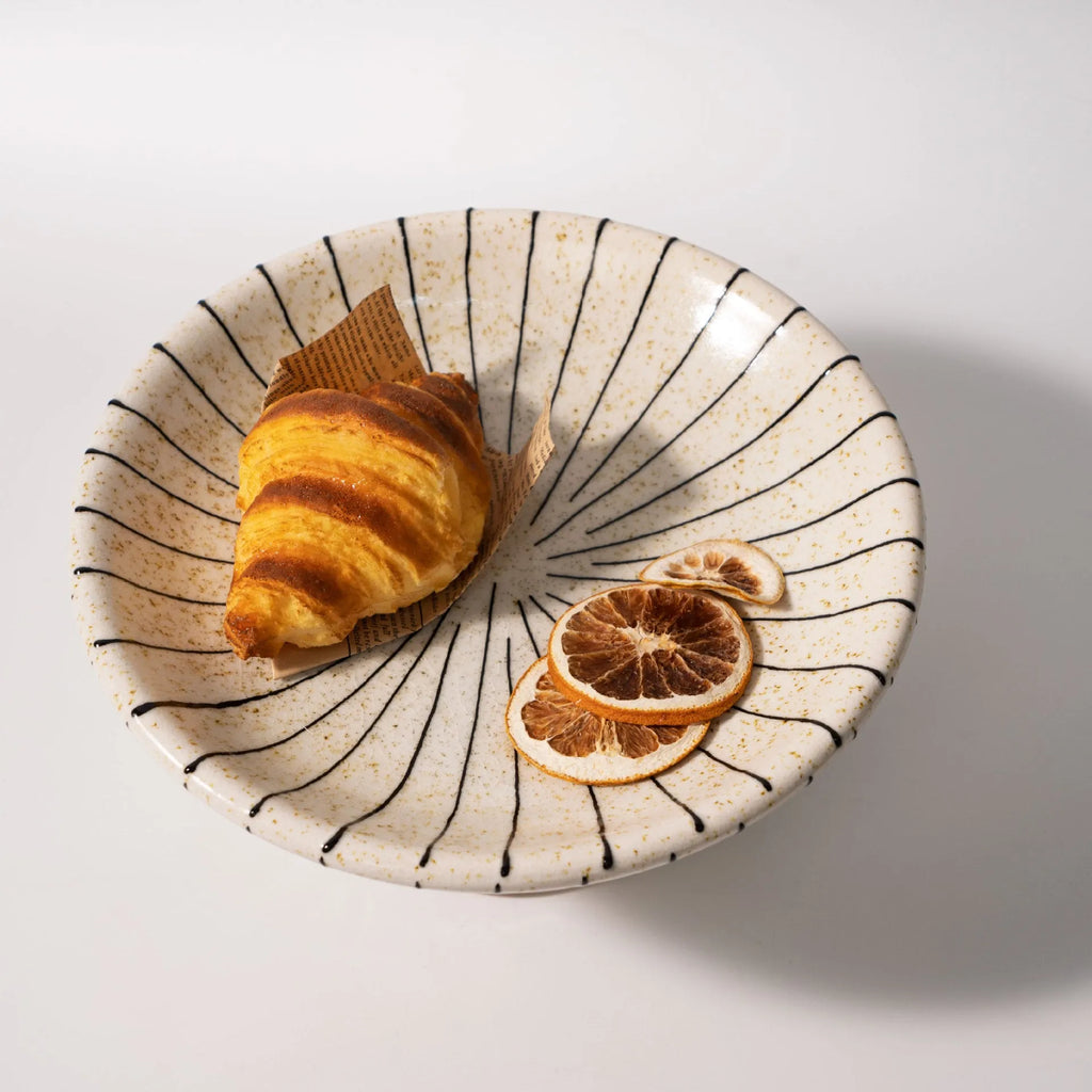 Retro style black and white striped synthetic resin fruit plate on a table.