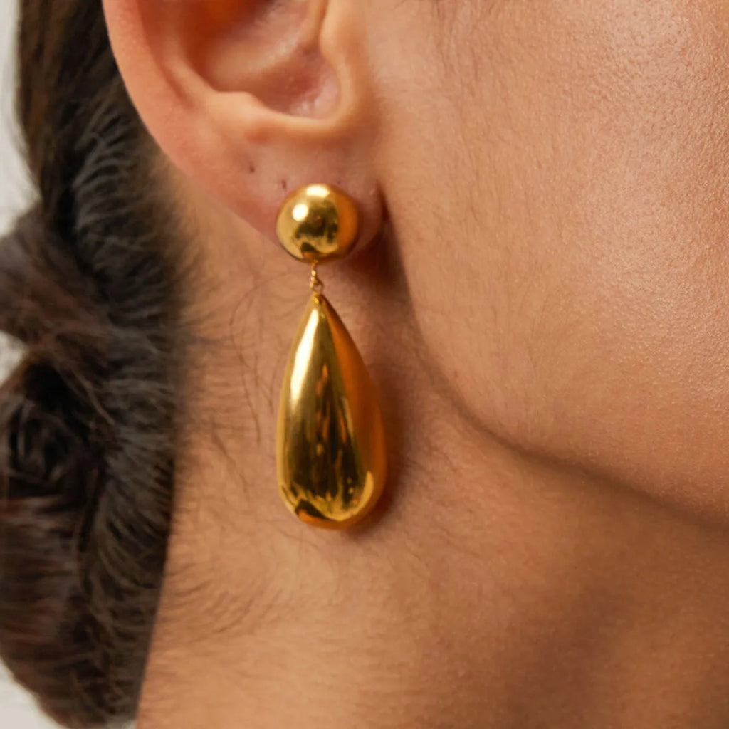 Gold electroplated stainless steel earrings with geometric hemisphere water drop pendant design