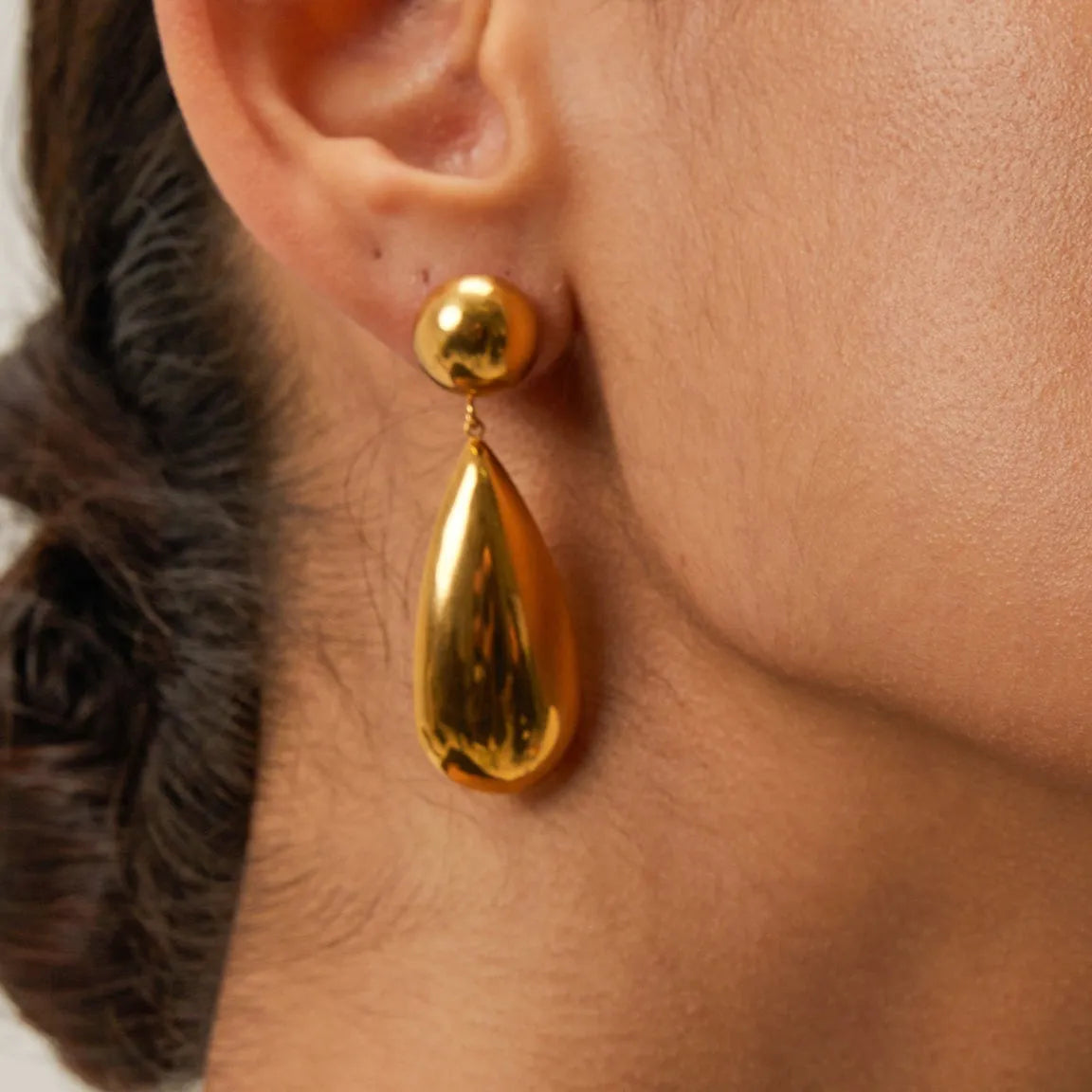 Gold electroplated stainless steel earrings with geometric hemisphere water drop pendant design