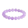 Lavender round amethyst bead bracelet with geometric water ripple design on a wrist.
