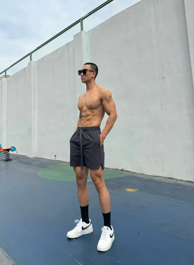 Man wearing ice silk quick-drying double-layer casual shorts in a light grey colour.