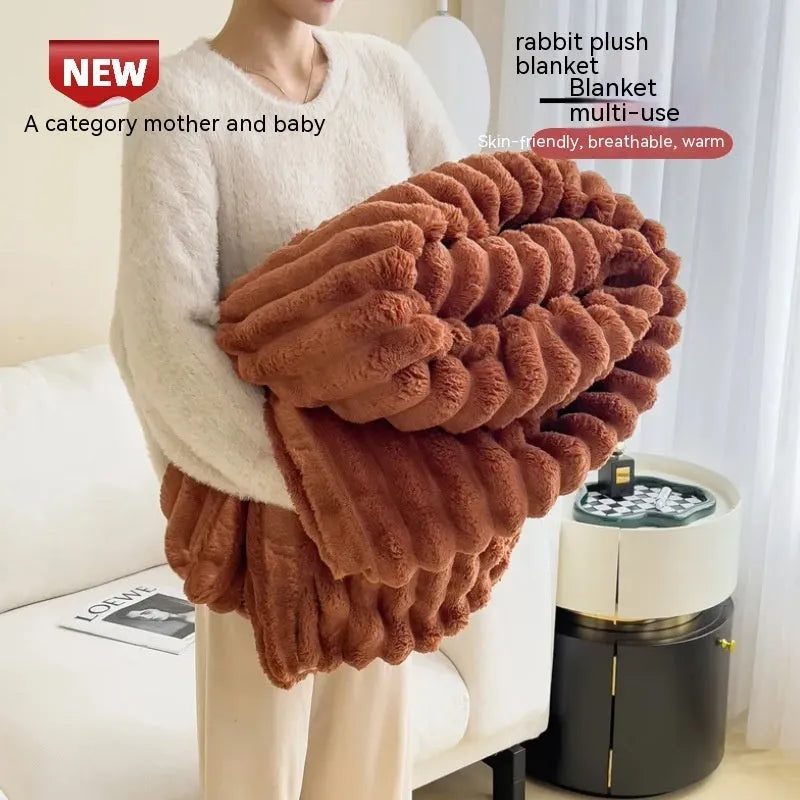 Solid colour double-sided thickening faux rabbit fur blanket in blue on a sofa