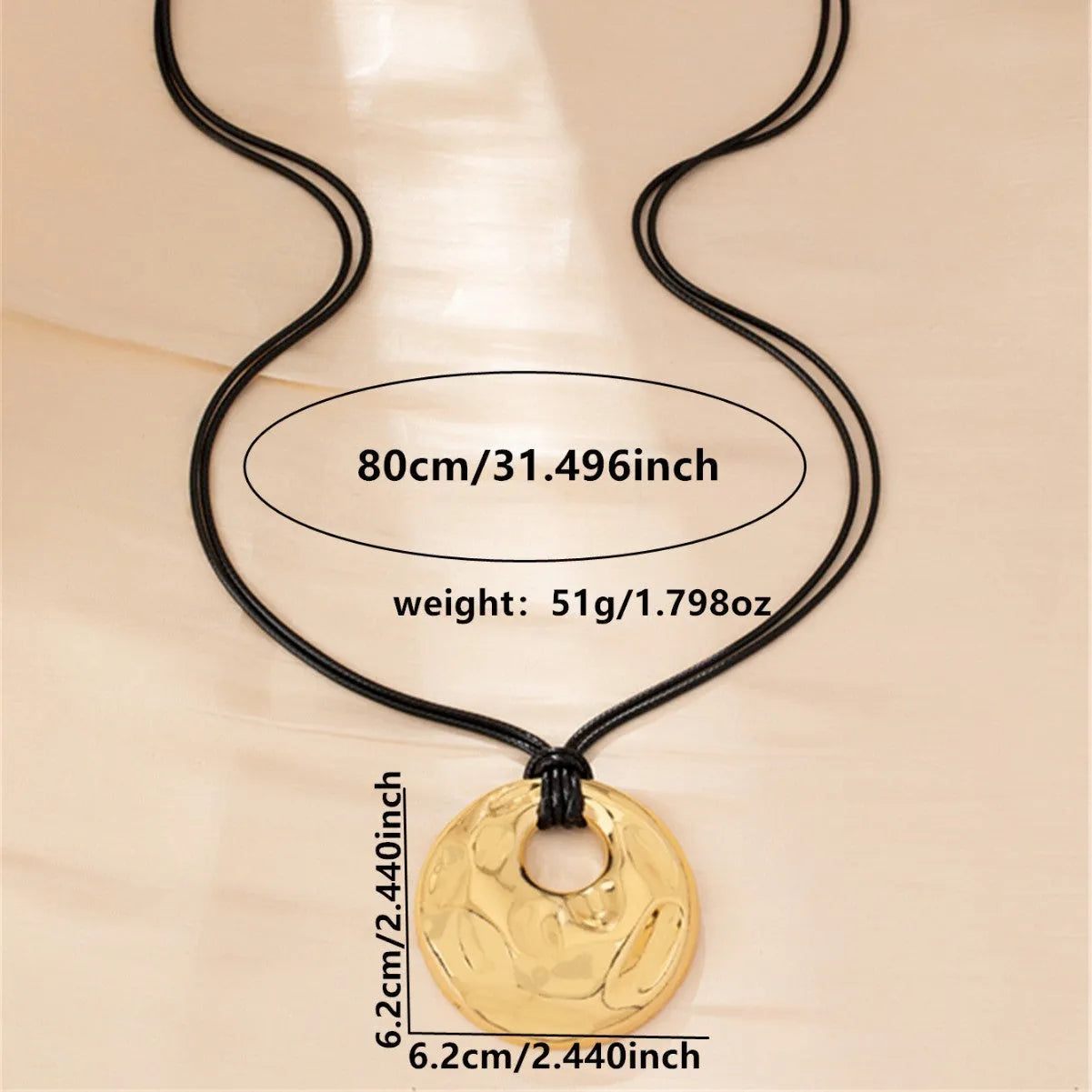 Women's gold alloy oval pendant necklace with braided rope chain on a plain background