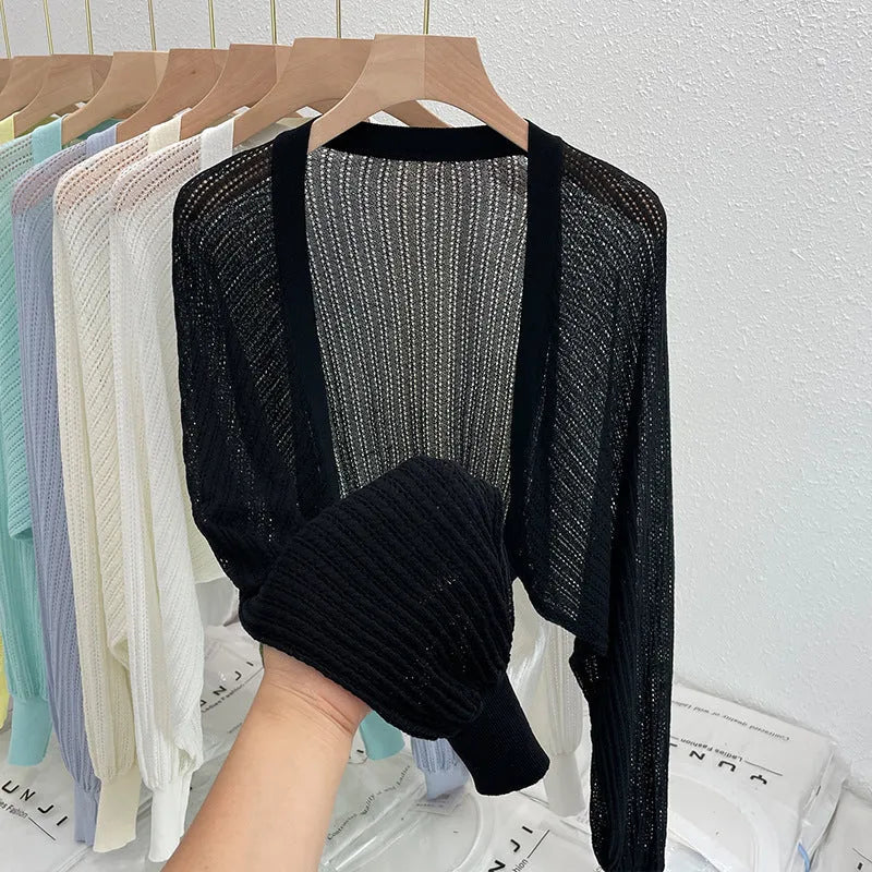 Women's apricot coloured blouse with long loose lantern sleeves and a hollow linen-look weave.