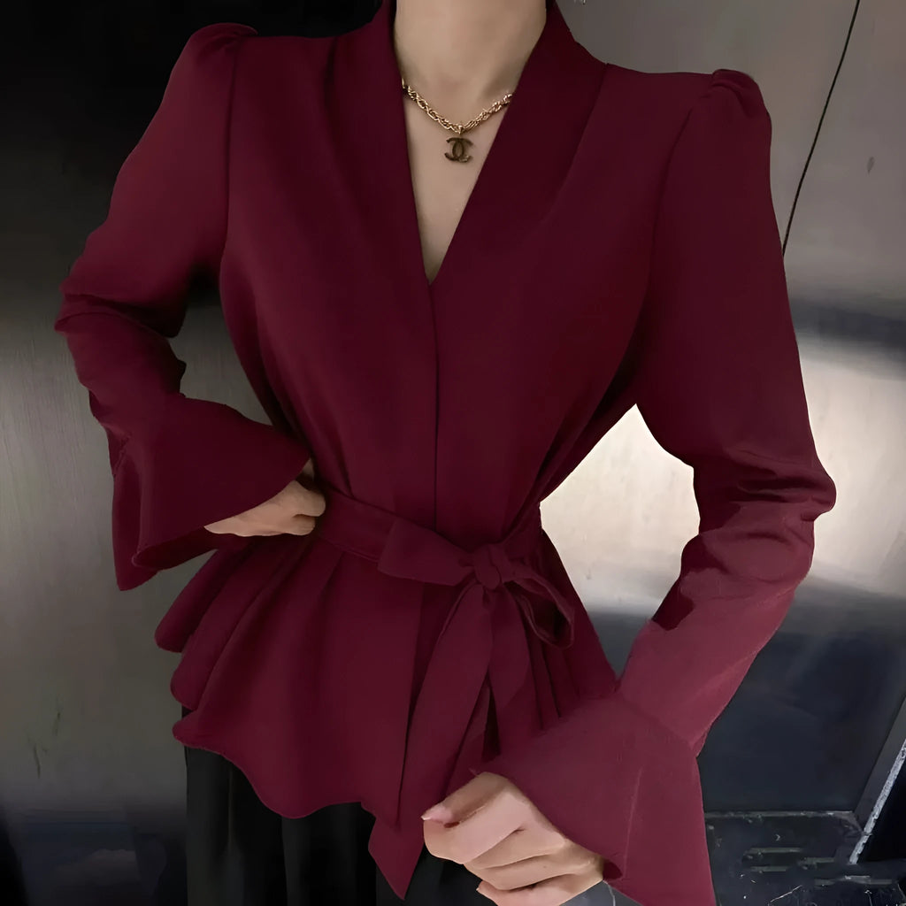 Women's black French-style shirt with irregular collar, long bell sleeves, and tied front detail.