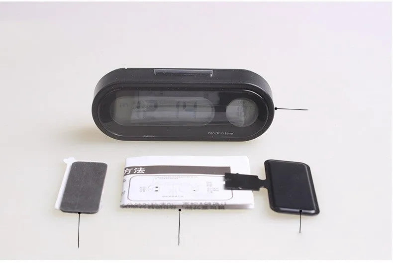 Black car dashboard clock thermometer with digital LED display showing time and temperature