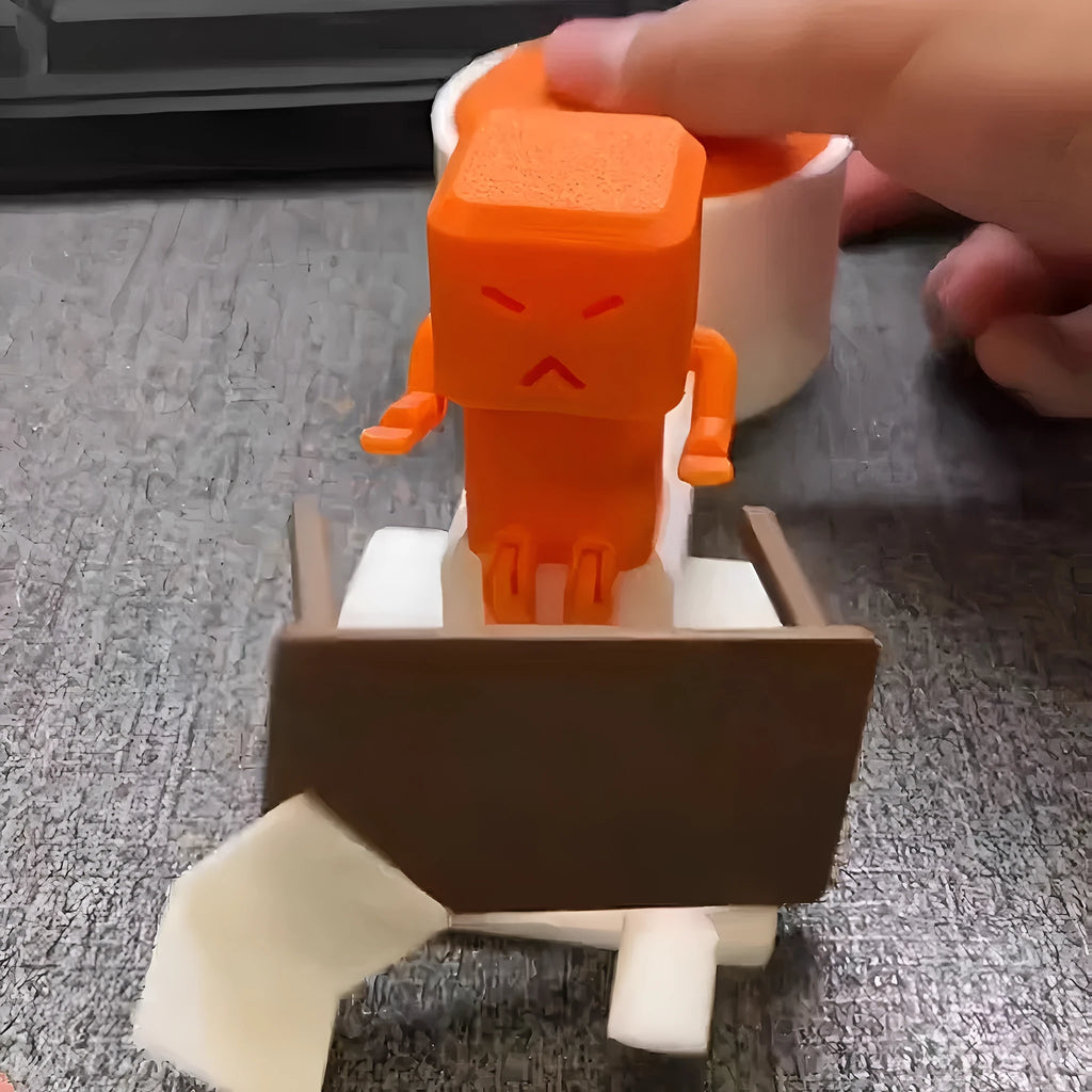 Orange plastic table turning decompression toy on desktop surface