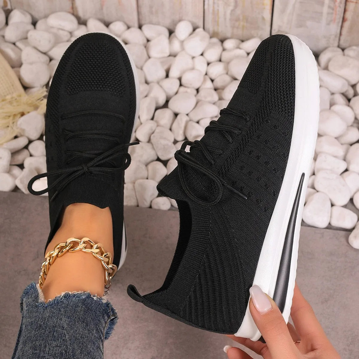Women's low-top fly-knit sneakers in red with round toe and lace-up front.