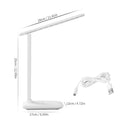 White plastic USB rechargeable bedside lamp with touch dimming control on a wooden surface.