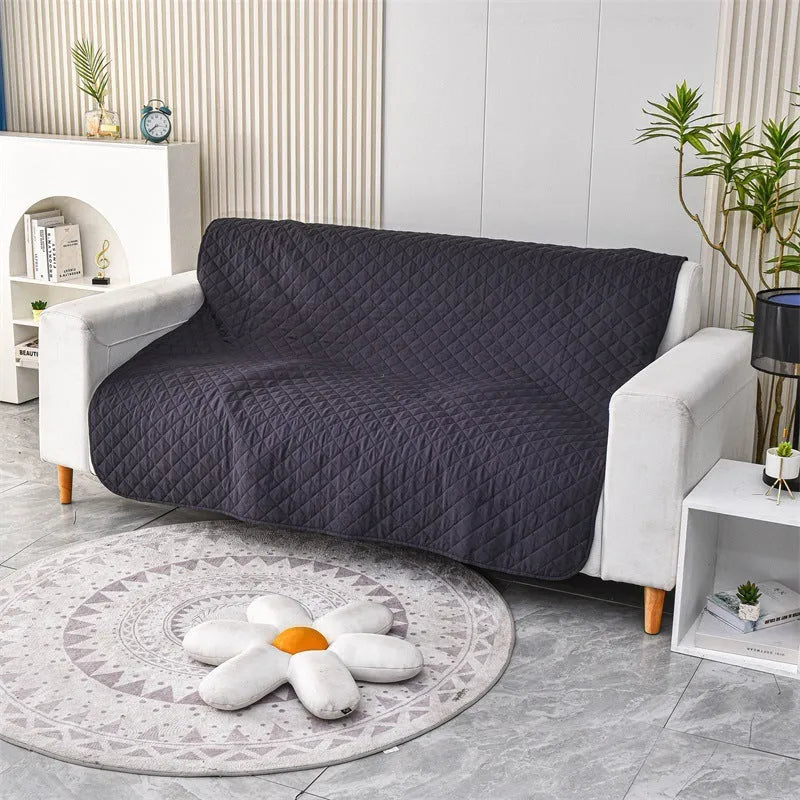 Reversible waterproof dog blanket on a sofa in burgundy colour, showing double-sided design