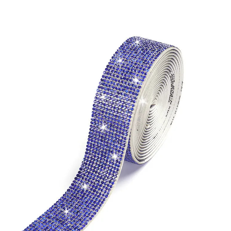 Close-up of a self-adhesive electroplated glass crystal strip on a roll for clothing decoration.