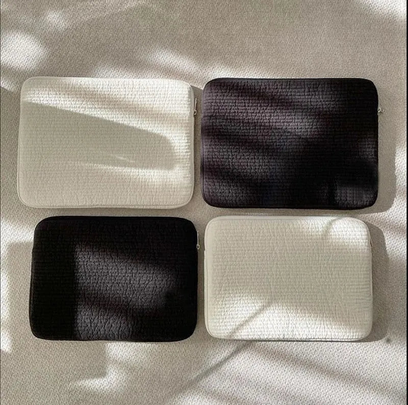 A black or white cotton cloth clutch-style anti-seismic laptop bag for tablet computers.