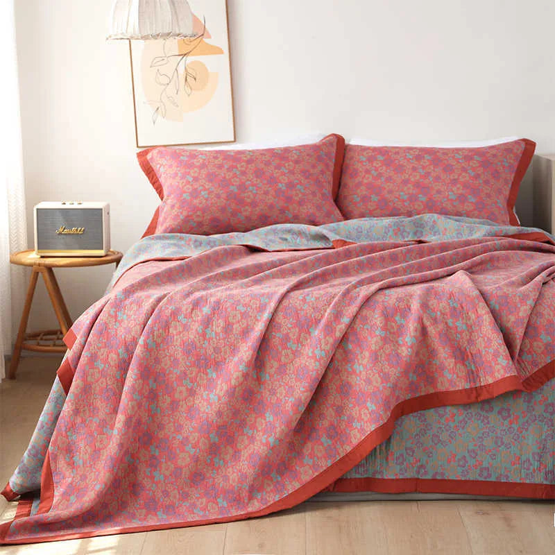Cotton gauze bedding three-piece set showing botanical flower pattern on blanket and matching pillowcases