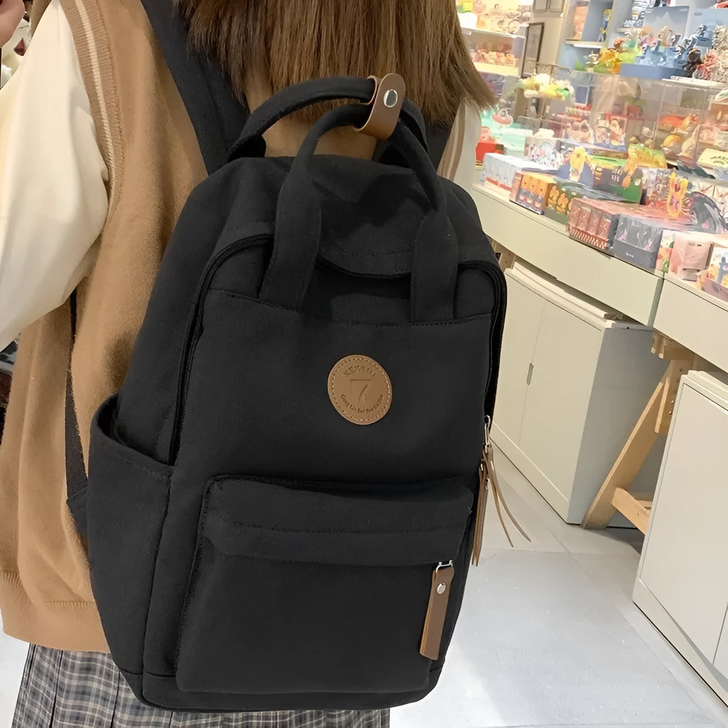 Black Oxford cloth leisure backpack with curved shoulder straps and urban simplicity styling