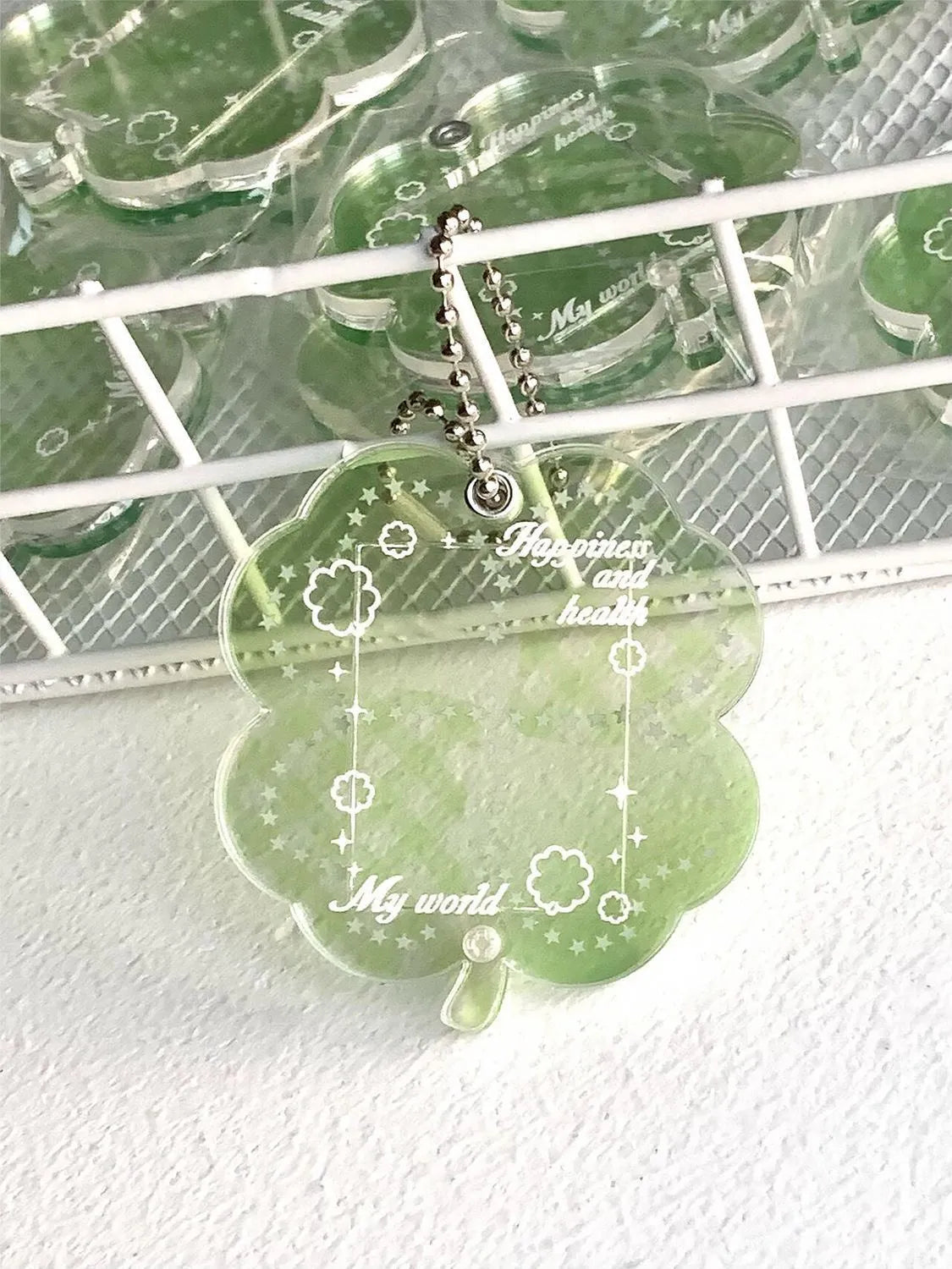 Acrylic four-leaf clover pendant keychain for phones in blue, green, or mint.