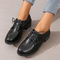 Black women's low-top shoes with a thick chunky heel and rubber sole.