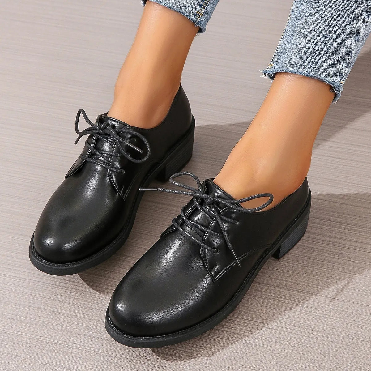 Black women's low-top shoes with a thick chunky heel and rubber sole.