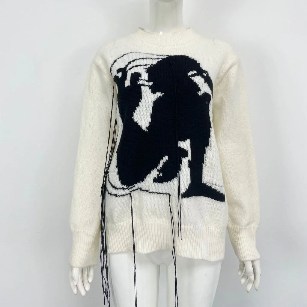 Grey and white women's alpaca wool sweater with tassel detail and abstract pattern.