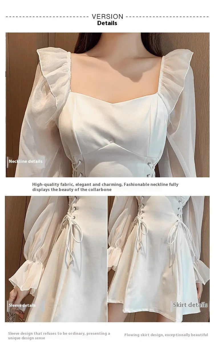 White chiffon patchwork dress with long sleeves and a waist-slimming silhouette on a hanger.