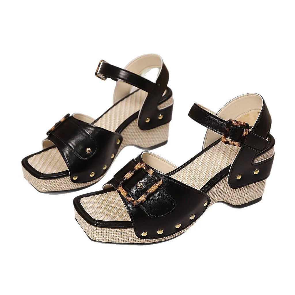 White women's square-toe chunky heel sandals with a prominent metal buckle fastening on the strap.