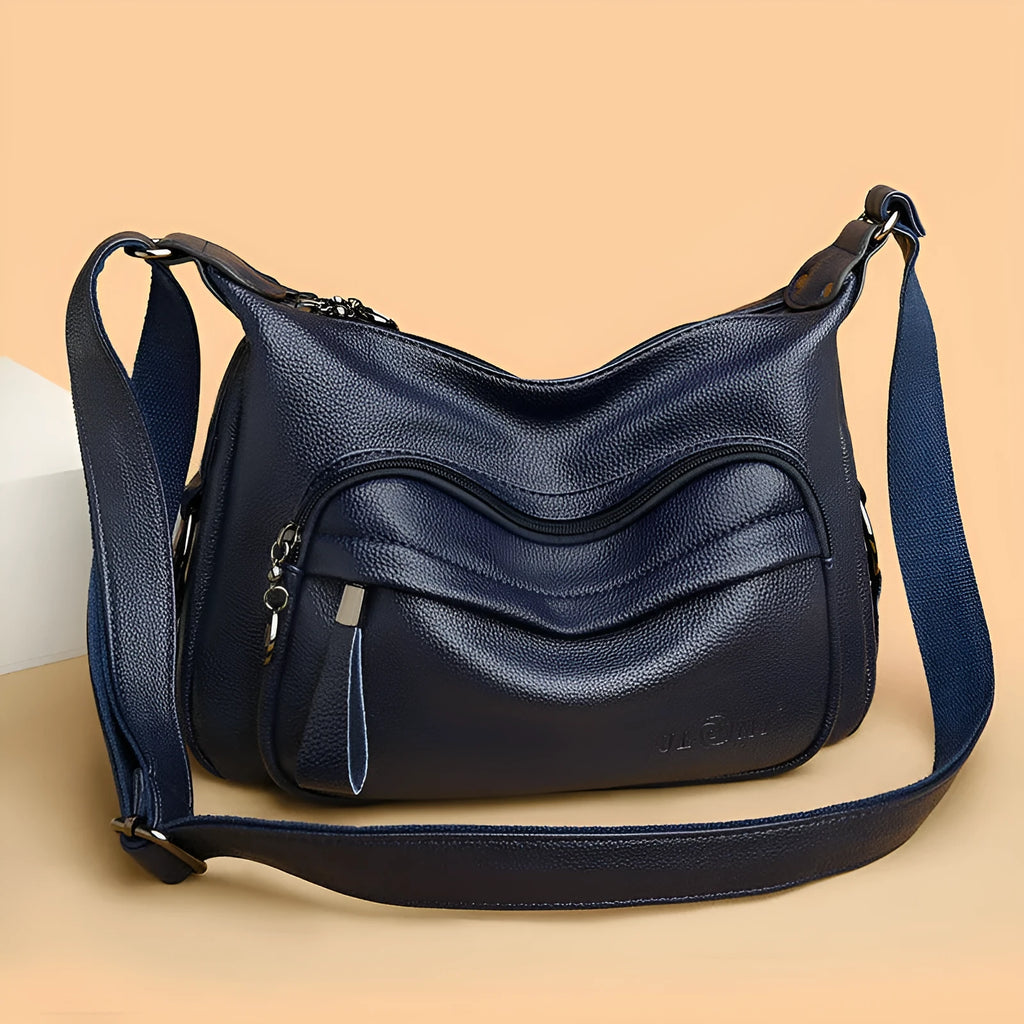 Women's blue crossbody shoulder bag with multiple interior pockets and zip closure