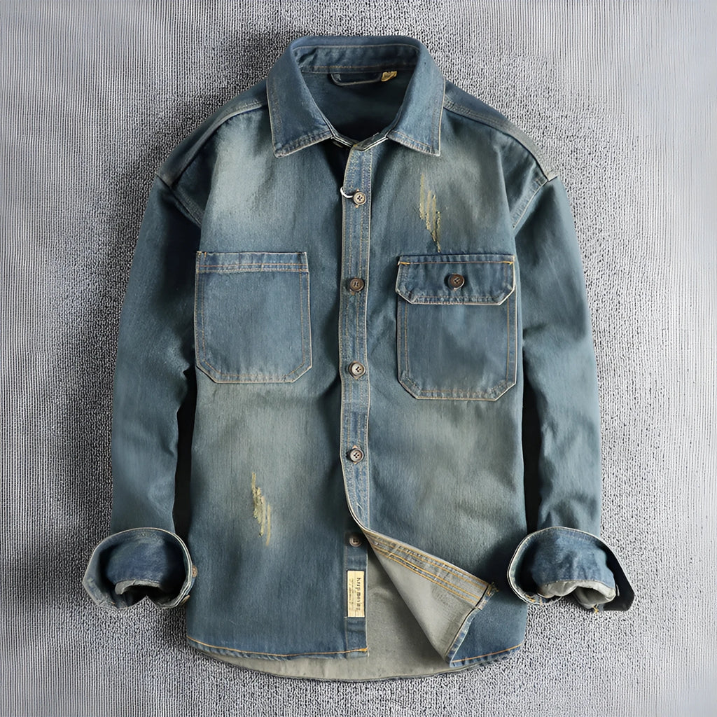 Men's light blue washed vintage denim shirt with a loose fit and long sleeves on a hanger.