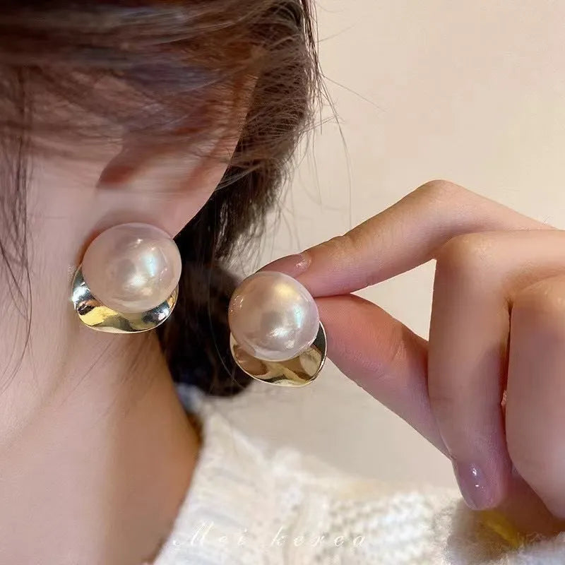 Alloy round stud earrings for women, casual style with metal finish, side view on model