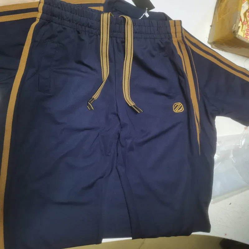 Man wearing a blue ironing-free polyester sports suit set with short sleeves and matching trousers.