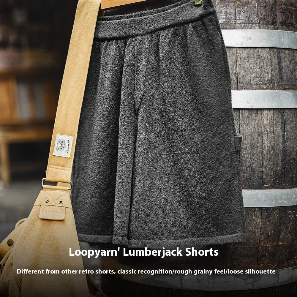 Cement grey straight leg sports shorts with a loose fit and elasticated waistband on a neutral background.