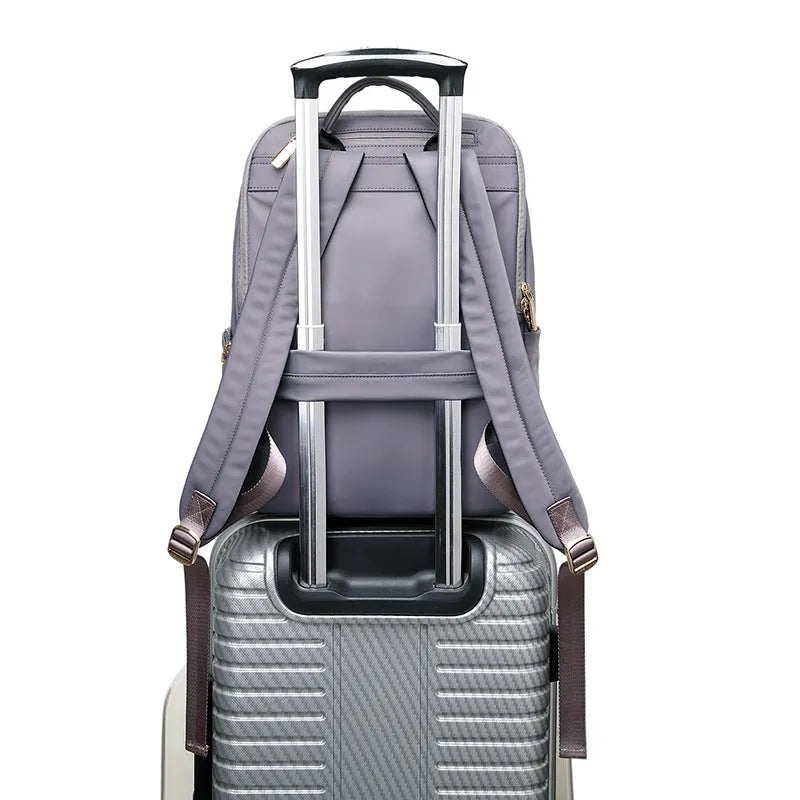 Women's large capacity oxford cloth backpack in black, showing front compartments and shoulder straps.
