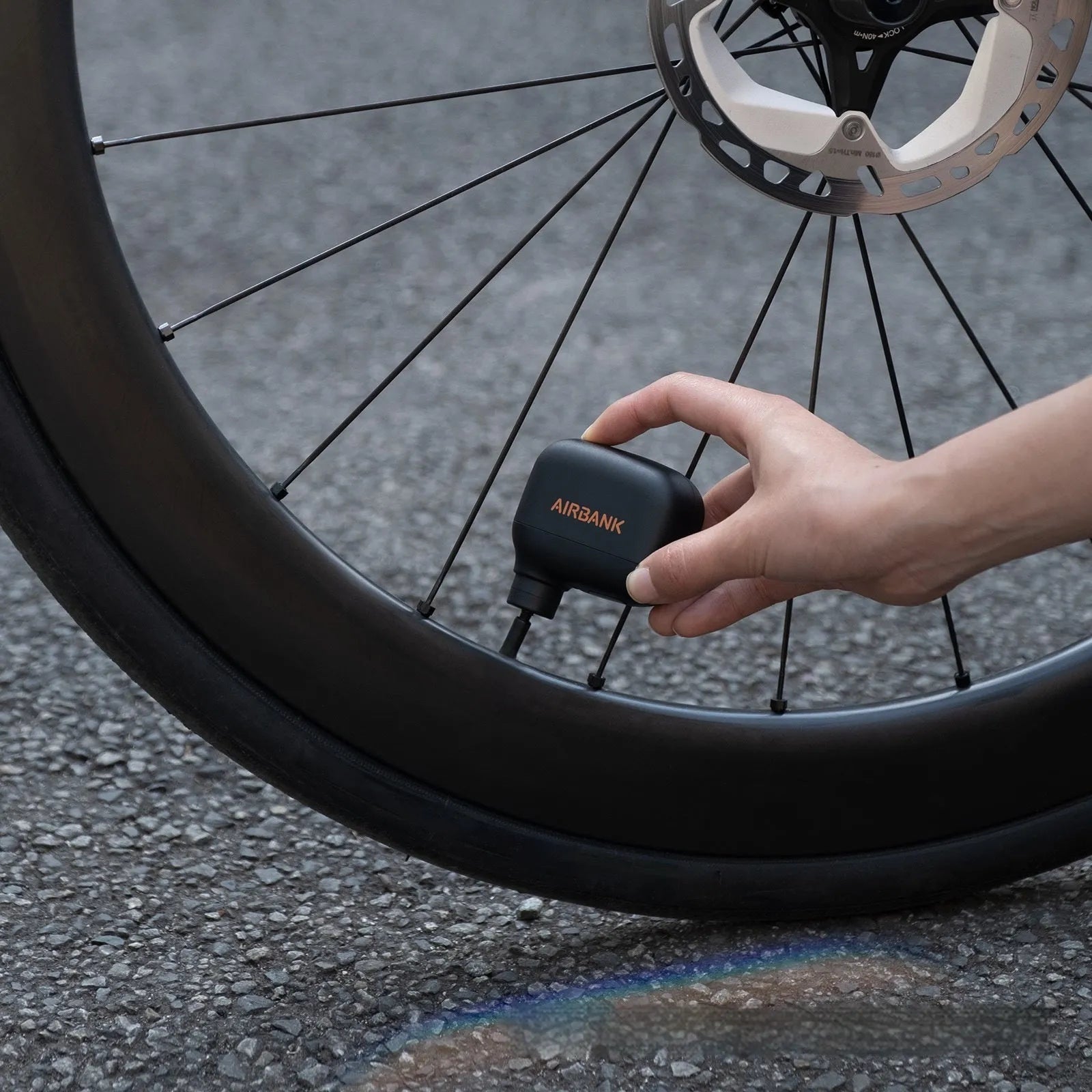 Black AS100 mini electric bicycle pump with USB charging cable and waterproof bag