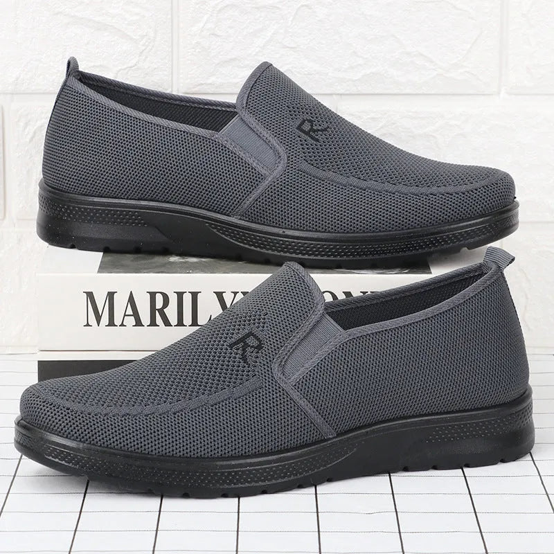 Men's black polyurethane slip-on shoes with breathable mesh upper and flat heel for casual wear