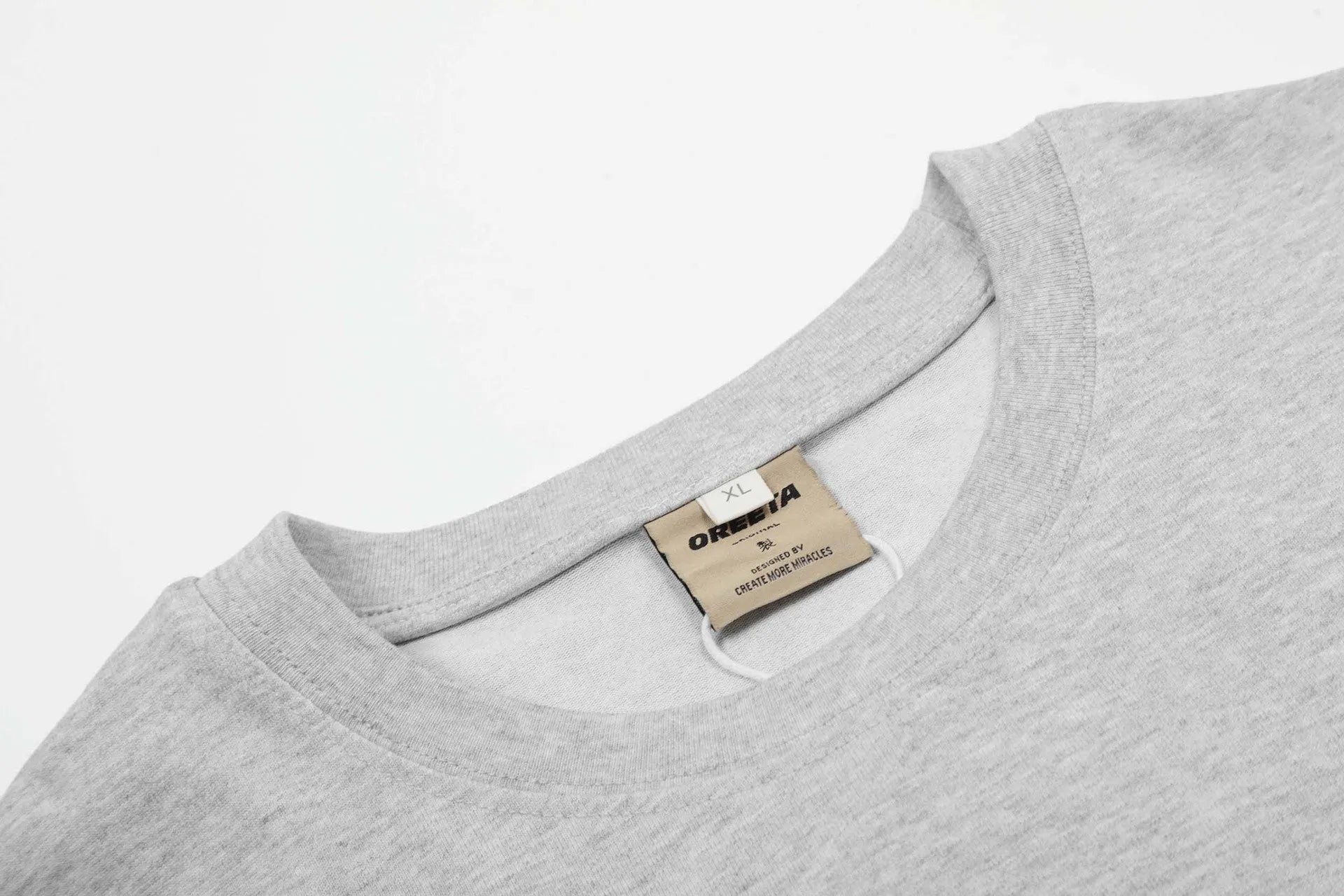 A man's loose-fit cotton pullover hoodie in a simple retro style, shown in grey colour.