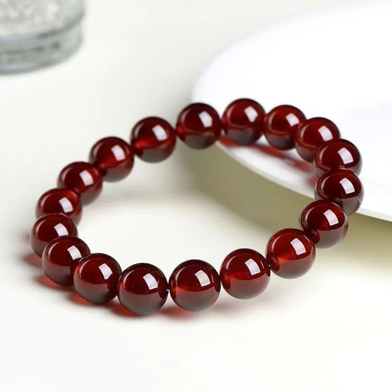 Crystal bracelet with natural orange red garnet beads and traditional Chinese ruyi charm in retro unisex design