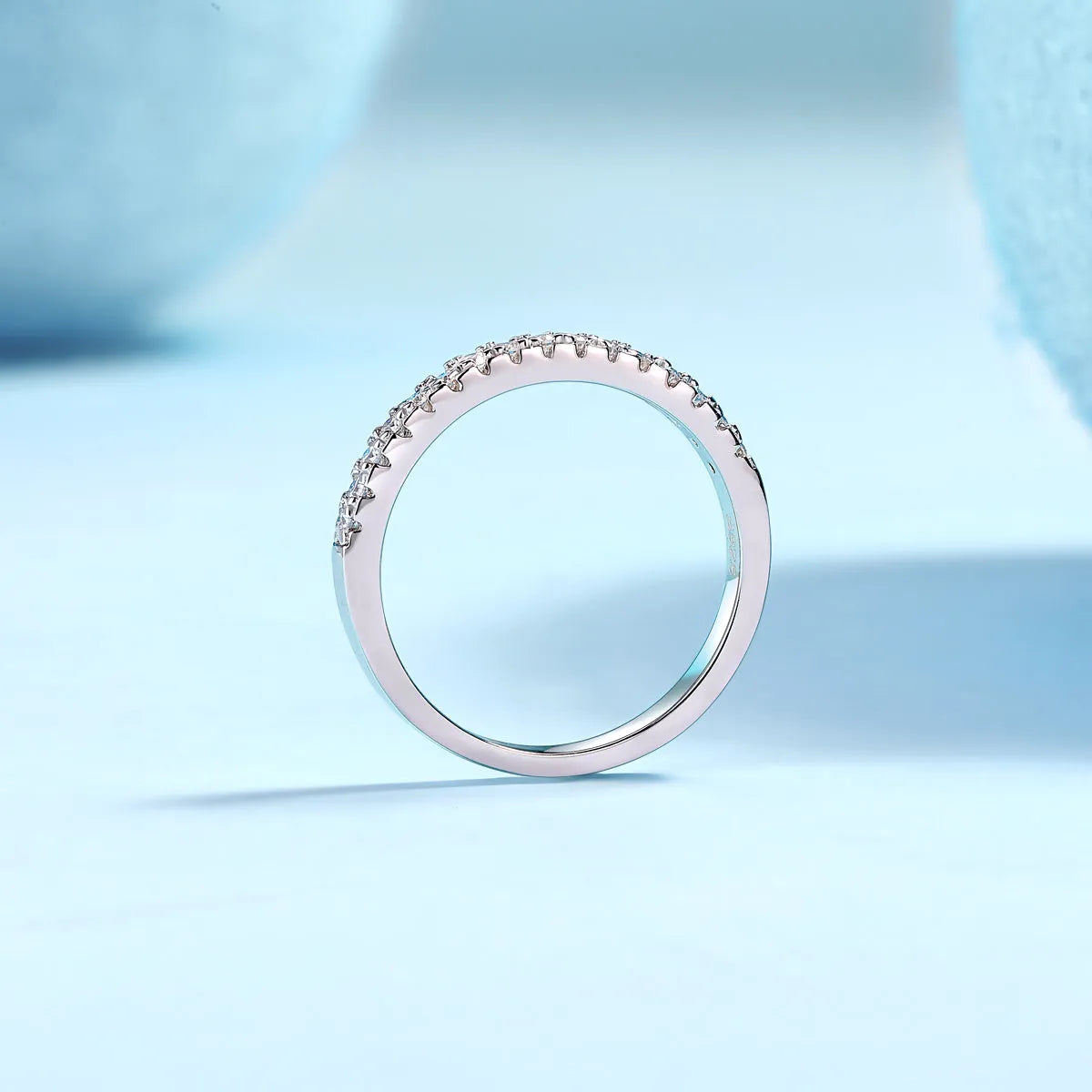 Parallel World moissanite wedding ring set in gold and rose gold on a gift box