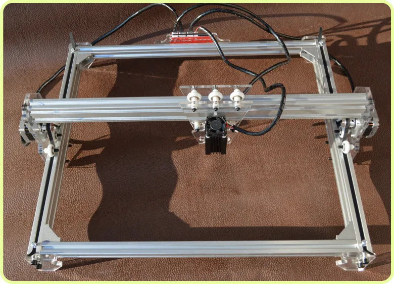Miniature desktop laser engraving machine with 400mm by 300mm base plate for marking and lettering.