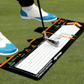 Black neoprene golf swing standing posture auxiliary pad on a practice surface.