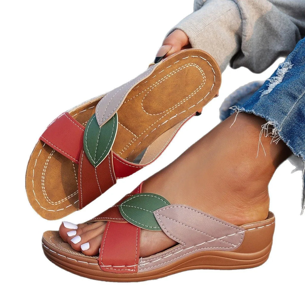Women's black cross-strap peep-toe slippers with a thick polyurethane sole on a white background.