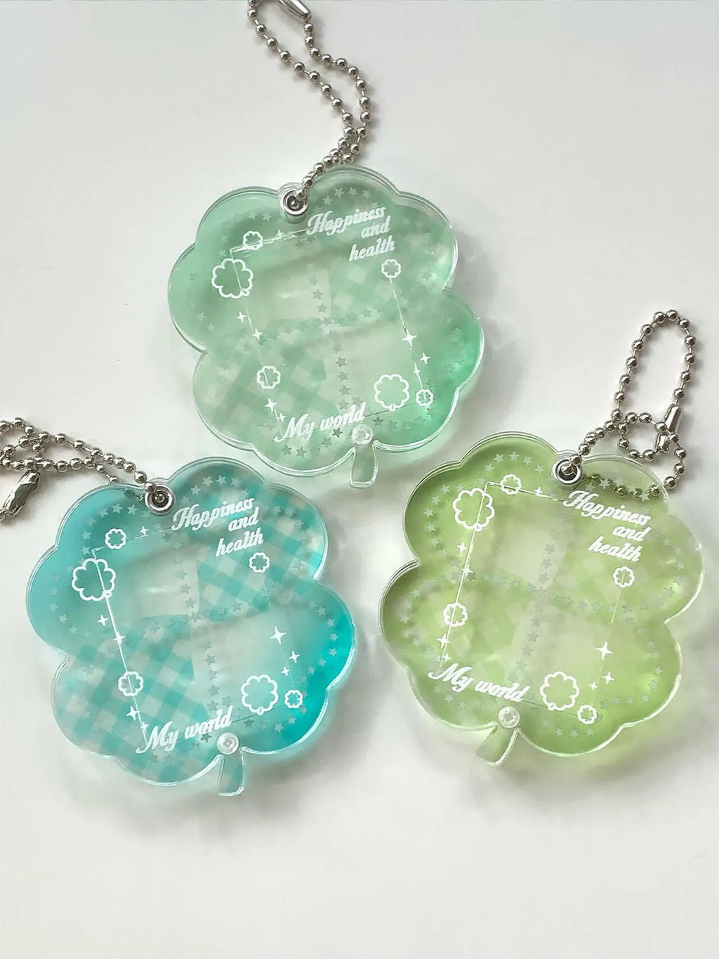 Acrylic four-leaf clover pendant keychain for phones in blue, green, or mint.