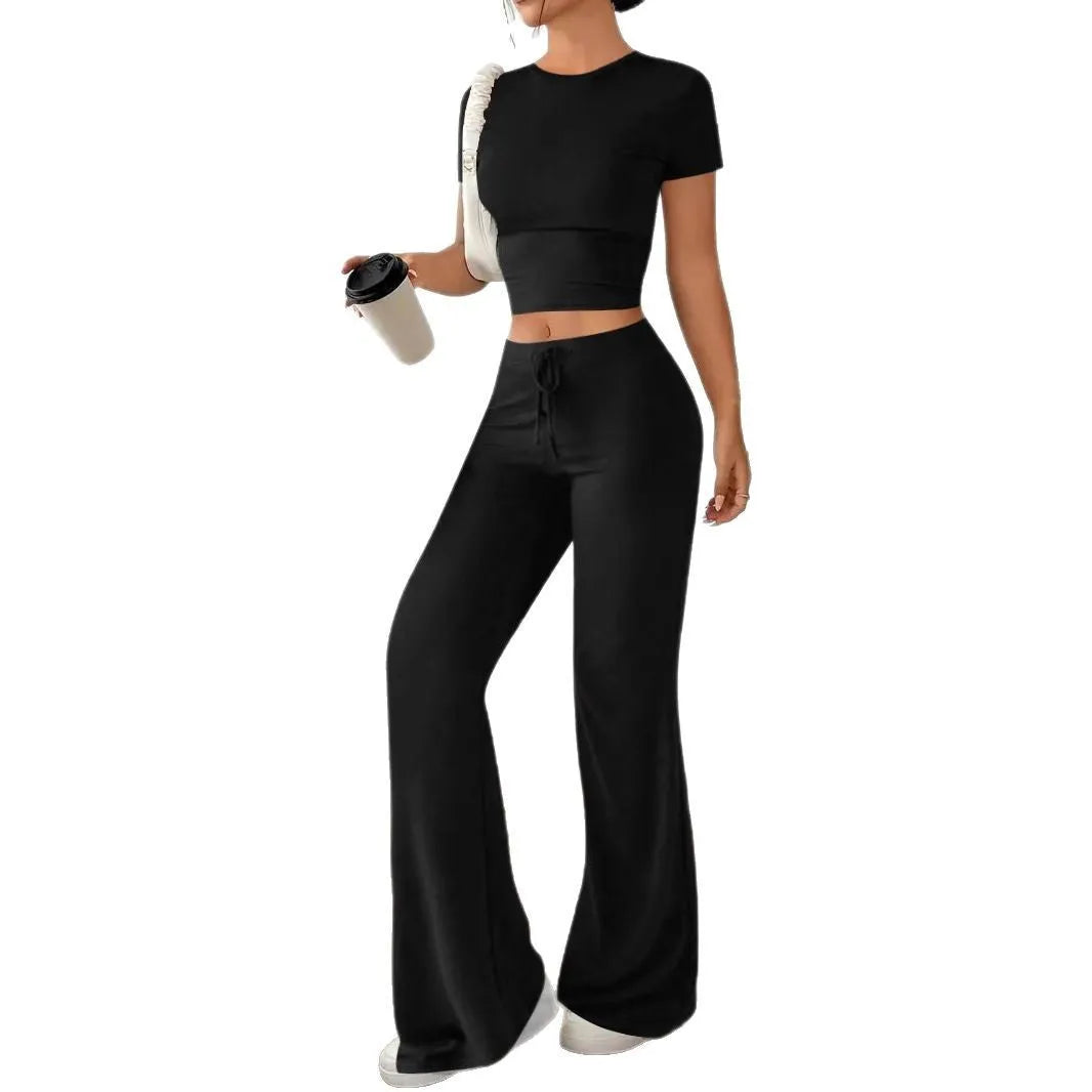 Black high-waist trousers and short-sleeve T-shirt co-ord set laid flat.