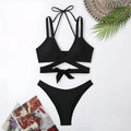 Women's solid colour strap bikini swimsuit showing briefs style in one of five colour options