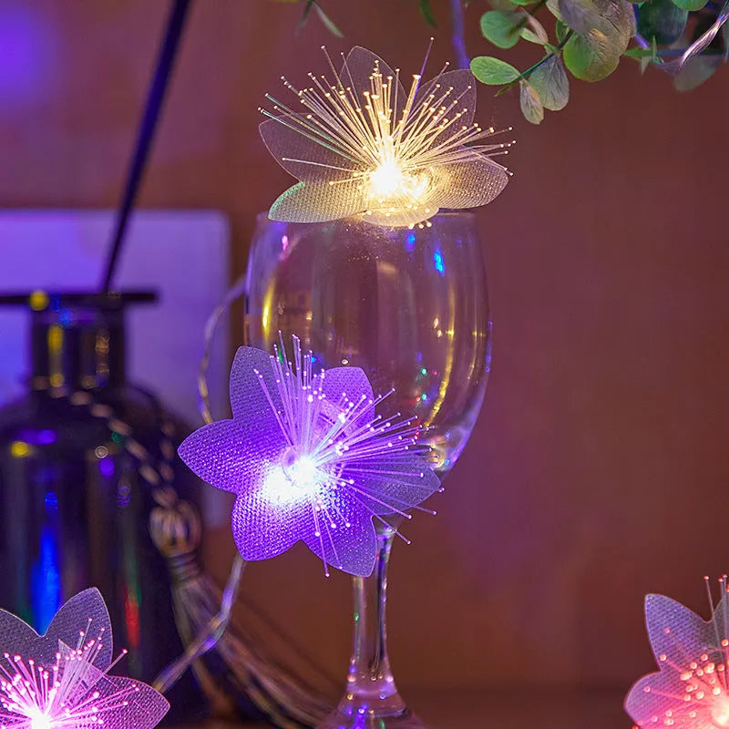 LED optical fiber flower light string with 20 warm white beads and plastic shell, battery powered, available in 1.5m to 100m lengths.